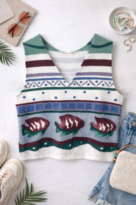 Sleeveless tank top with fish pattern on a white surface with accessories around